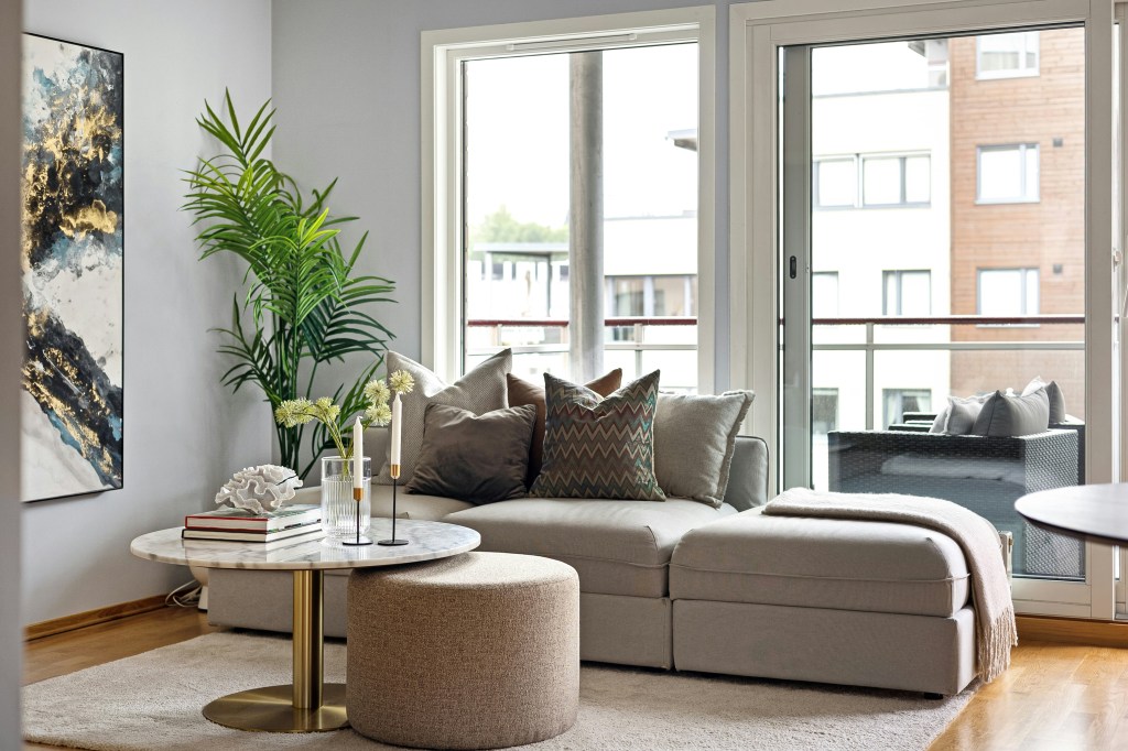 Curved sectional sofa and round coffee table creating a soft, cozy modern living room.