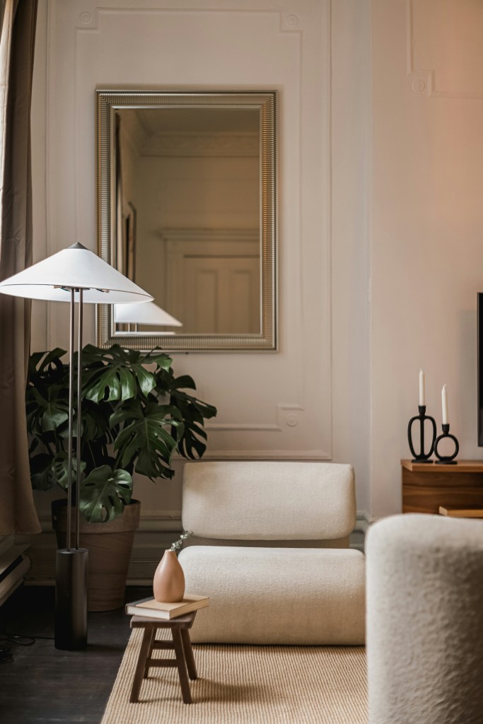 Neutral cozy living room with soft upholstered seating and warm minimalist winter decor.