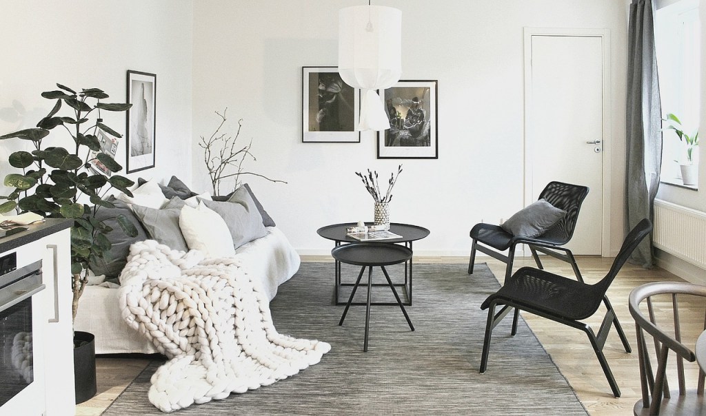 Cozy winter living room with chunky textured rug, layered throws, and soft neutral decor.