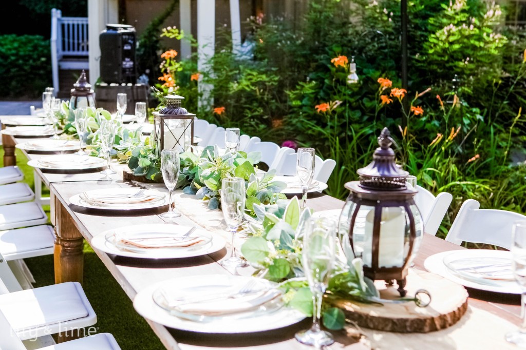 Romantic candlelit wedding reception tables at night with floral centerpieces and warm lighting, showcasing an elegant wedding theme.