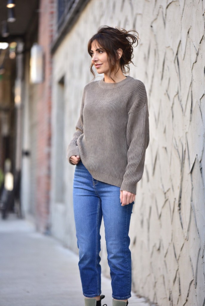 Relaxed casual winter outfit featuring blue jeans styled with a cozy knit jersey